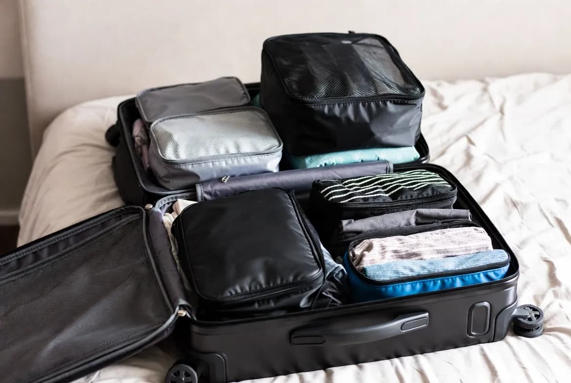 Open packed suitcase showing carry on luggage size and packing cubes