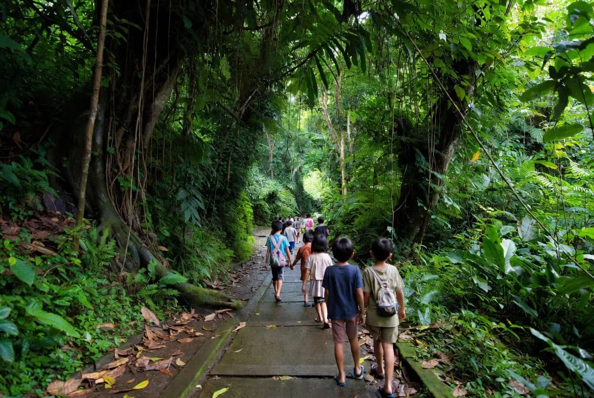 Children looking at the lush green jungle pathways inside the Sacred Monkey Forest in Ubud